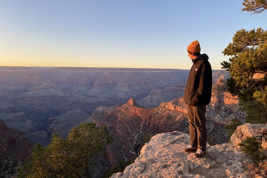 Standing on a canyon edge at sunset
